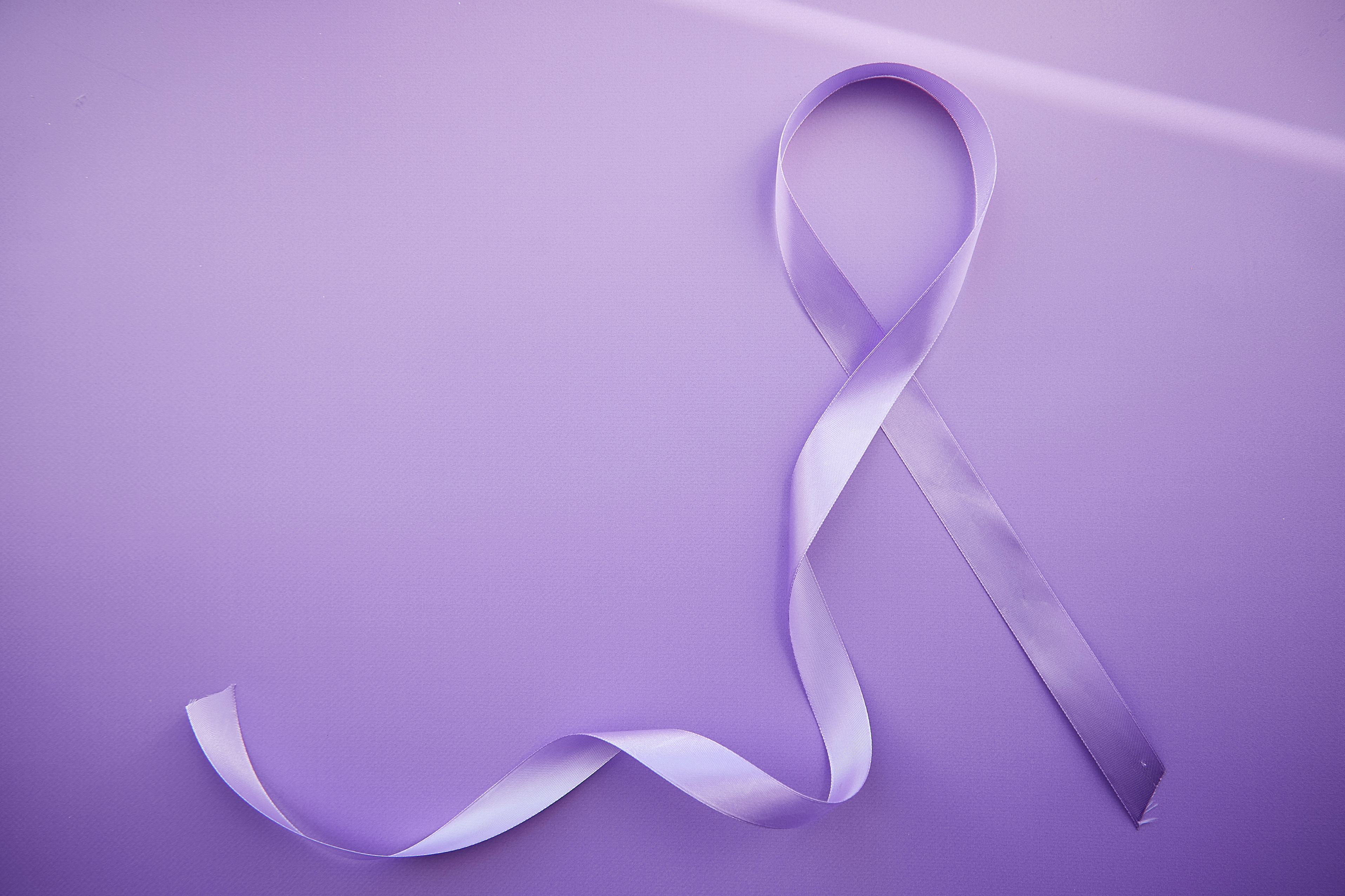 Purple ribbon for Purple Day - World Epilepsy Day, March of 26. Symbol of Epilepsy Day on purple background with shadows